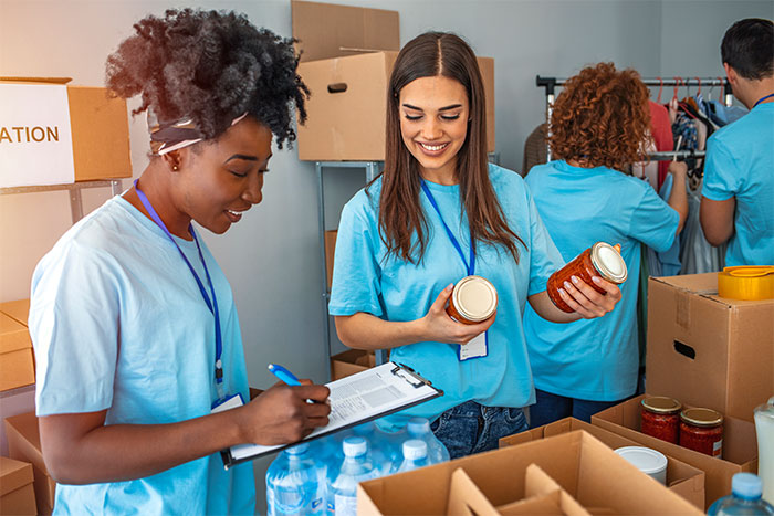 Two non-profit workers taking inventory of donations