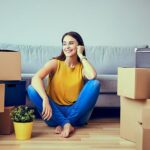 Women sitting in her new apartment covered by renter's insurance